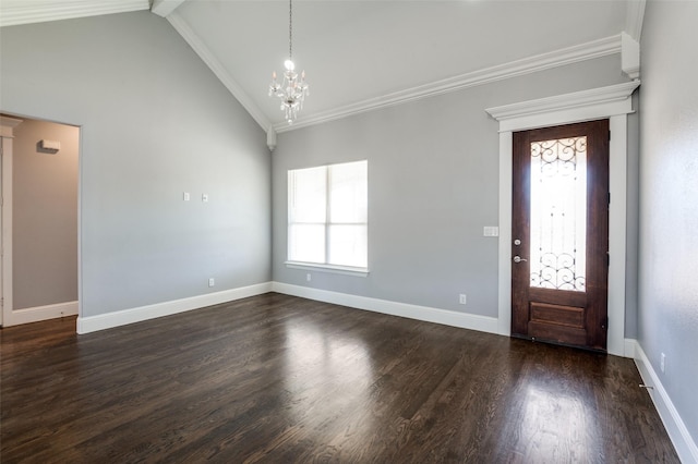 entrance foyer with an inviting chandelier, a wealth of natural light, ornamental molding, and dark hardwood / wood-style floors