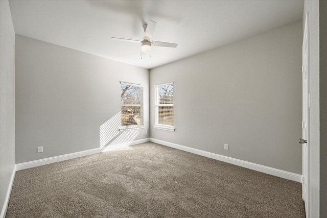 spare room with dark colored carpet and ceiling fan