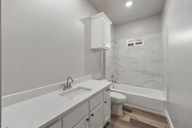 full bathroom with vanity, toilet, hardwood / wood-style floors, and tiled shower / bath