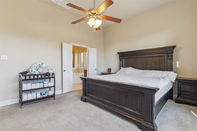 carpeted bedroom with ceiling fan and ensuite bath