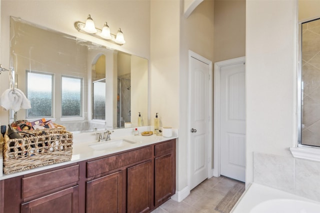 bathroom featuring tile patterned flooring, vanity, and independent shower and bath