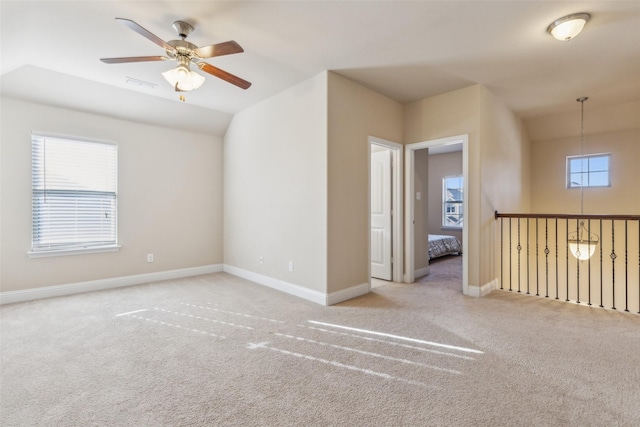 carpeted empty room featuring a healthy amount of sunlight and ceiling fan