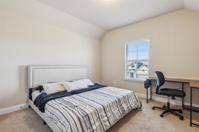 carpeted bedroom featuring lofted ceiling