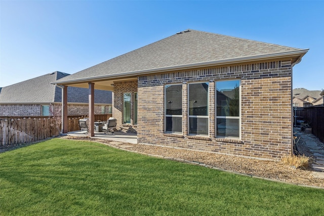 rear view of house featuring a patio and a lawn