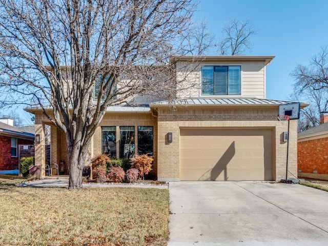 view of front of home featuring a garage and a front yard