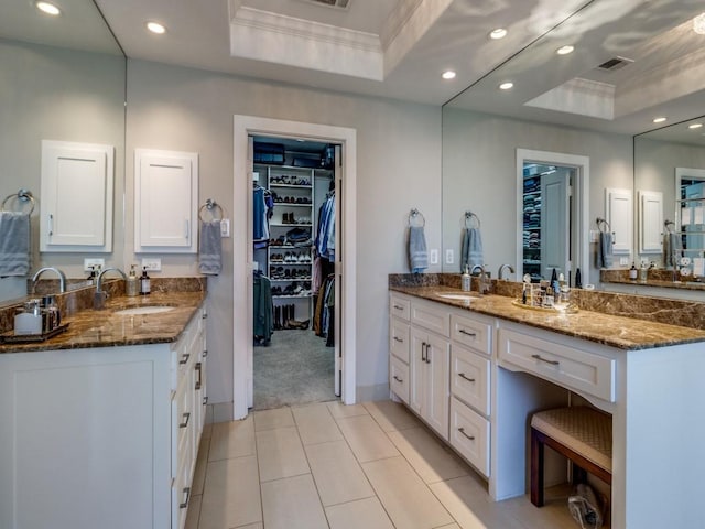 bathroom featuring crown molding, vanity, and a tray ceiling