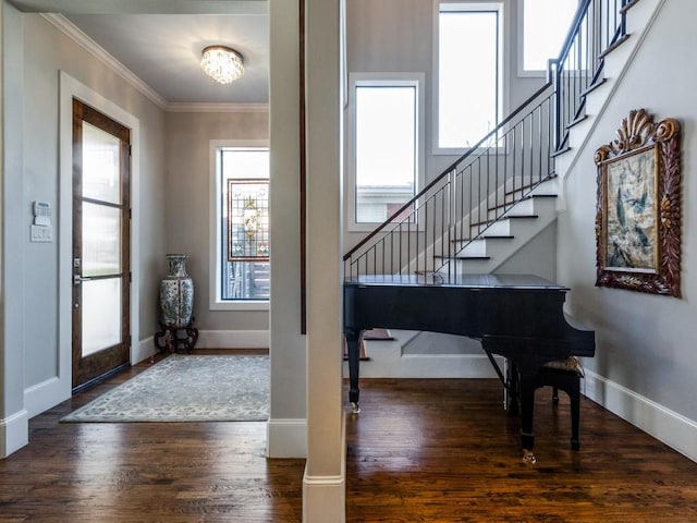 entryway with ornamental molding and dark hardwood / wood-style floors