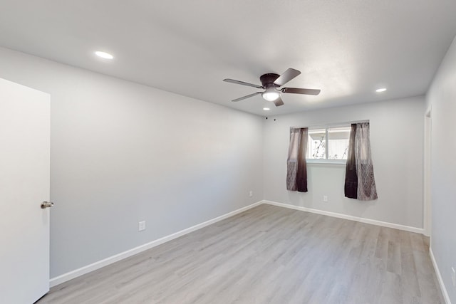 spare room featuring ceiling fan and light hardwood / wood-style flooring