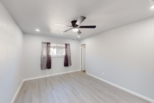 spare room featuring ceiling fan and light wood-type flooring