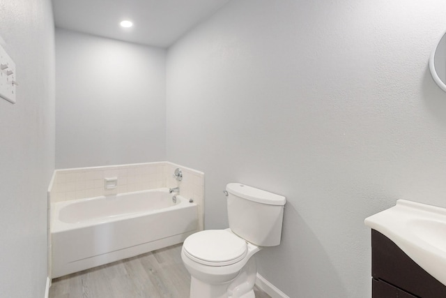 bathroom with vanity, wood-type flooring, a bathtub, and toilet