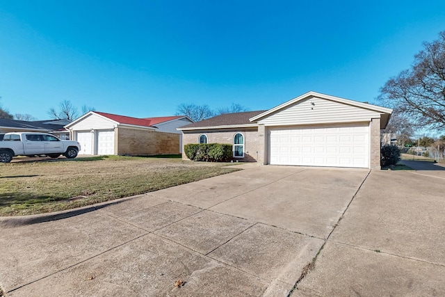 ranch-style home with a garage and a front lawn