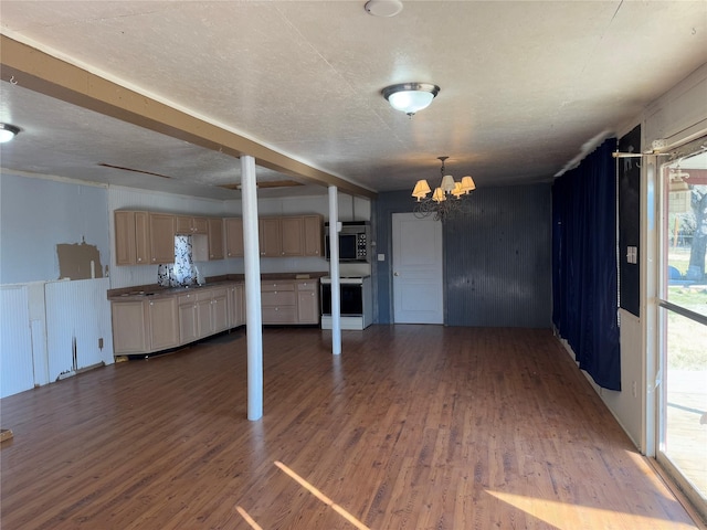 interior space with dark wood-style flooring, a notable chandelier, and a textured ceiling