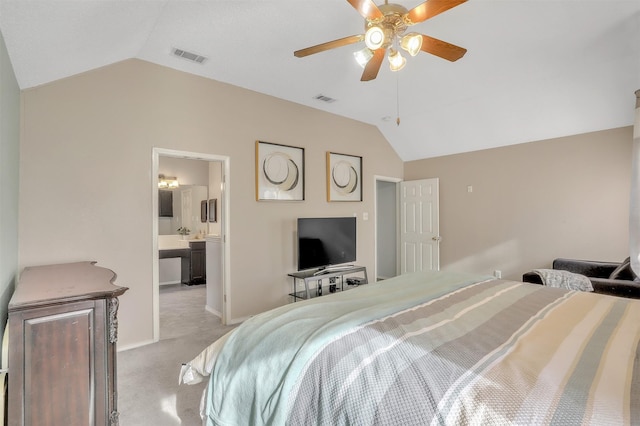 carpeted bedroom with connected bathroom, vaulted ceiling, and ceiling fan