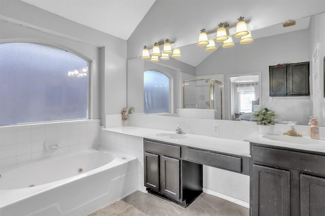 bathroom featuring vaulted ceiling, vanity, and plus walk in shower