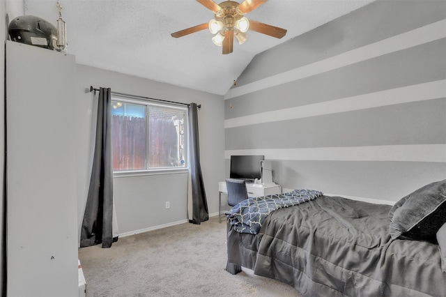 bedroom featuring vaulted ceiling, light carpet, a textured ceiling, and ceiling fan