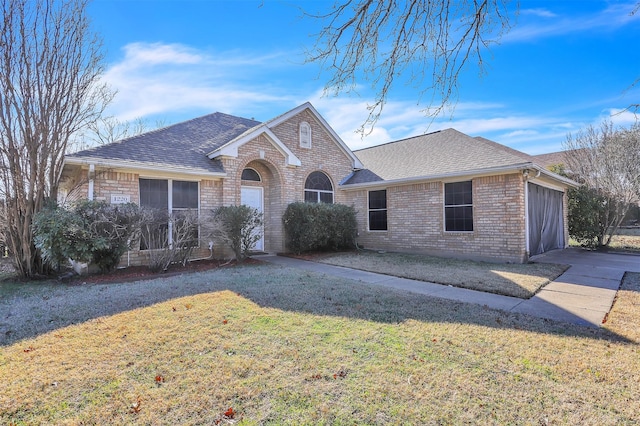 ranch-style house featuring a garage and a front yard