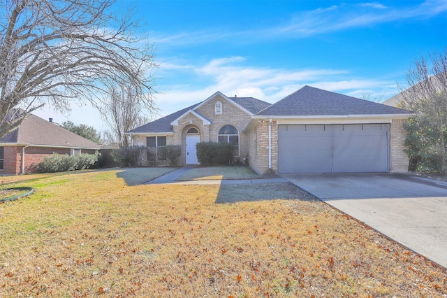 ranch-style home with a garage and a front lawn