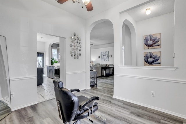 hallway featuring hardwood / wood-style floors and a textured ceiling