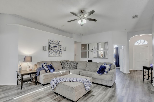 living room with ceiling fan and light hardwood / wood-style flooring