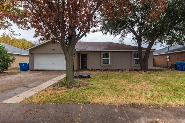 ranch-style home with a garage and a front lawn