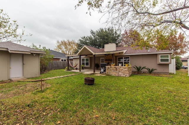 back of property with a yard and a patio