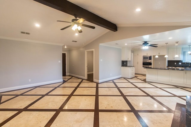 unfurnished living room with sink, lofted ceiling with beams, ornamental molding, and ceiling fan