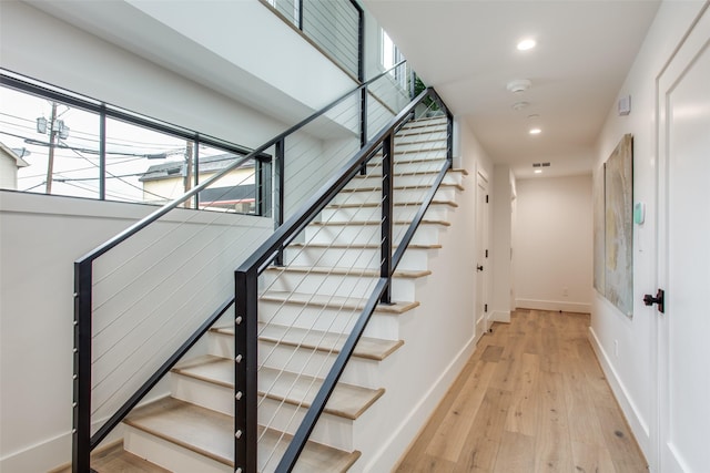 stairway featuring wood-type flooring