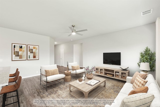 living room featuring dark wood-type flooring and ceiling fan