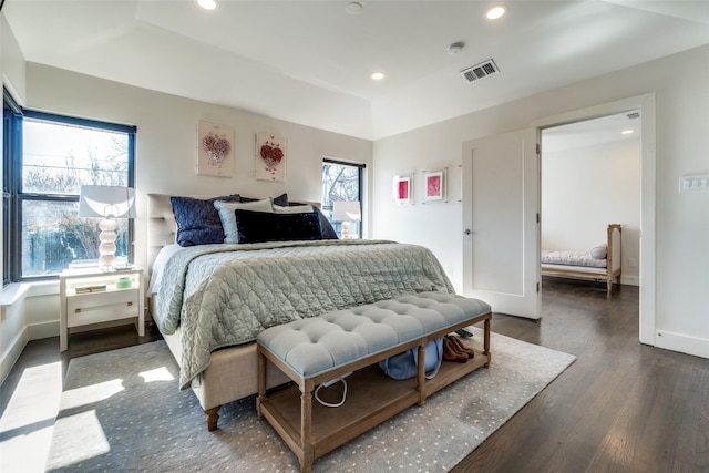 bedroom with dark hardwood / wood-style floors