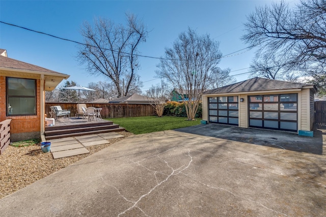 view of yard with a garage, an outdoor structure, and a deck