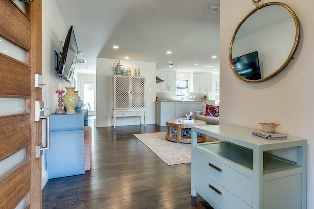 kitchen with white cabinetry, dark hardwood / wood-style flooring, extractor fan, and a wealth of natural light