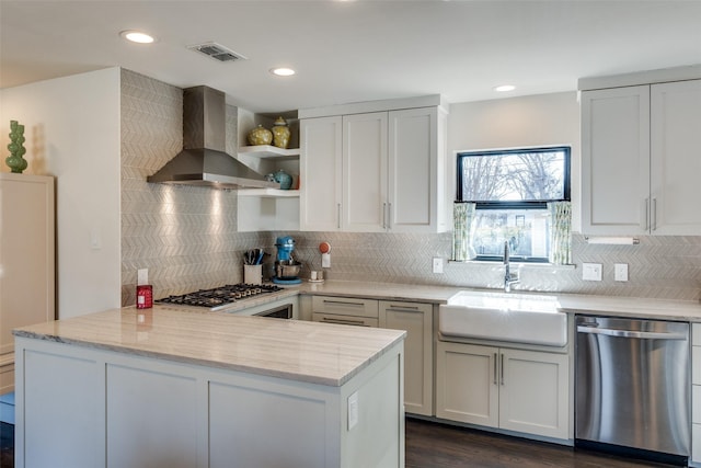 kitchen with sink, white cabinetry, ventilation hood, stainless steel dishwasher, and light stone countertops