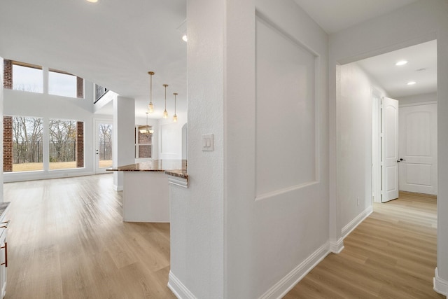 corridor with light hardwood / wood-style floors