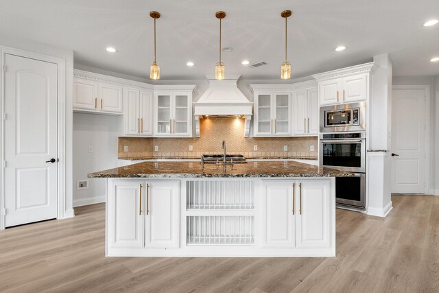 2491 Stonybrook Dr, Prosper, TX 75078 - kitchen featuring custom range hood, stainless steel appliances, arched walkways, recessed lighting, and a sink