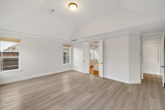 unfurnished room with lofted ceiling and light hardwood / wood-style flooring