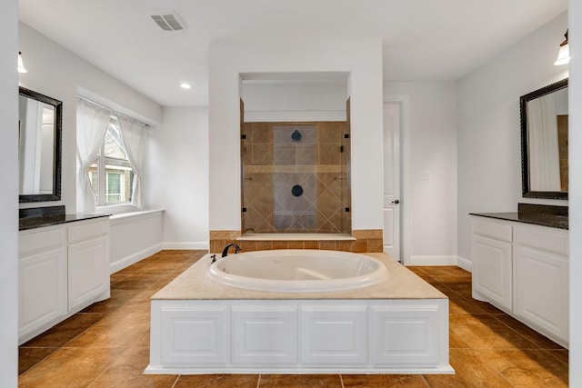 bathroom featuring tile patterned floors, vanity, and separate shower and tub