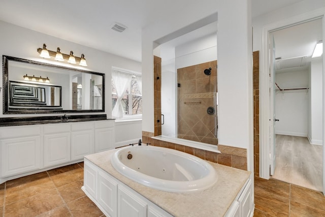 bathroom with plus walk in shower and vanity