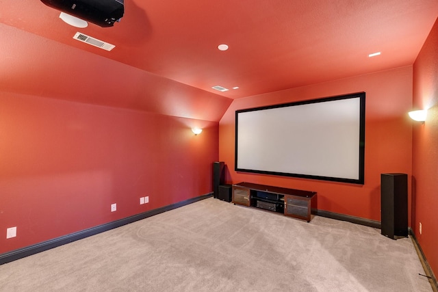 carpeted cinema featuring vaulted ceiling