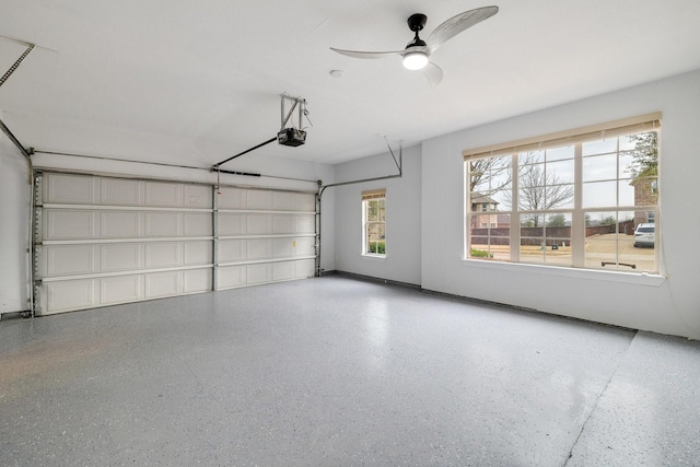 garage with a garage door opener and ceiling fan