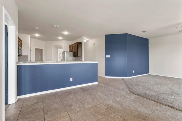 unfurnished living room featuring carpet flooring