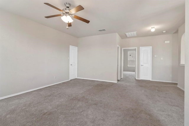 spare room with ceiling fan and dark carpet