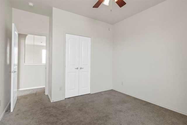 unfurnished bedroom featuring a closet, ceiling fan, and carpet