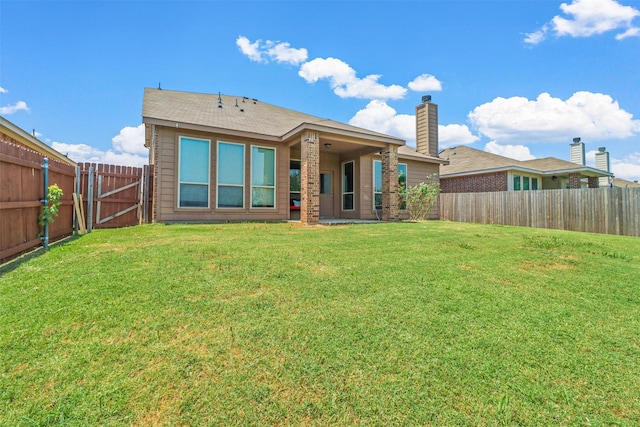 rear view of house with a lawn