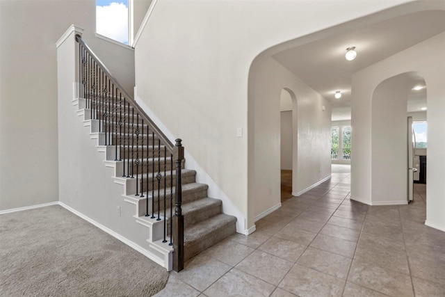 staircase with tile patterned floors