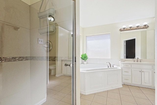 full bathroom featuring toilet, vanity, plus walk in shower, and tile patterned flooring