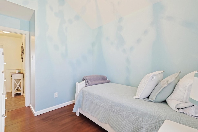 bedroom with dark hardwood / wood-style floors