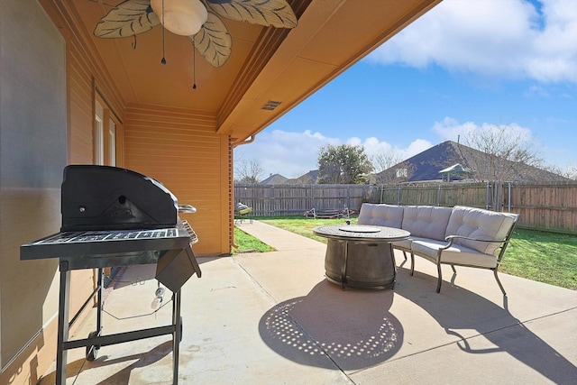 view of patio featuring grilling area, an outdoor living space with a fire pit, and ceiling fan