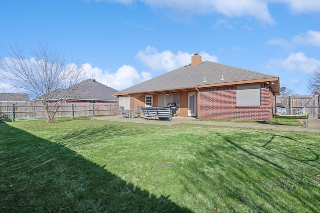 rear view of house with a yard and a patio area