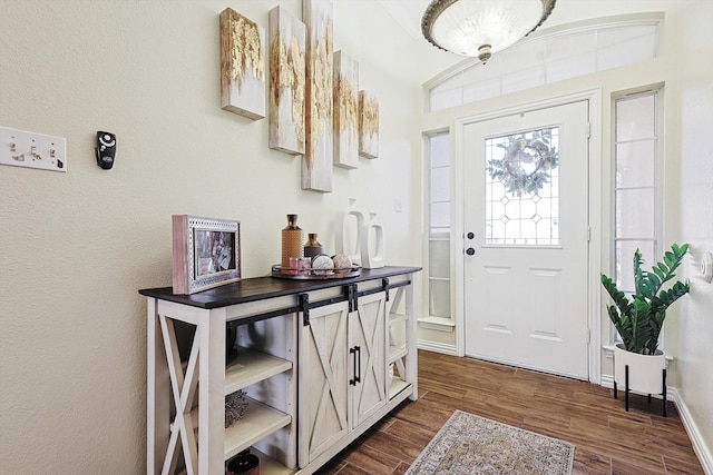 doorway to outside featuring lofted ceiling