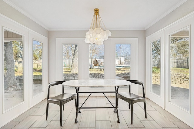 sunroom / solarium featuring an inviting chandelier